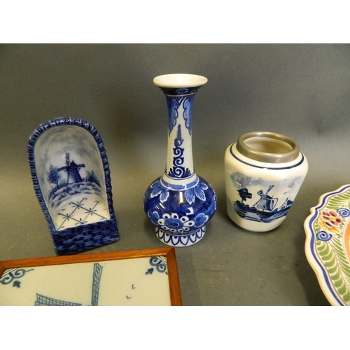 50P - A collection of Delft pottery to include three tiles, two small vases, a Wicca chair ornament, and t... 