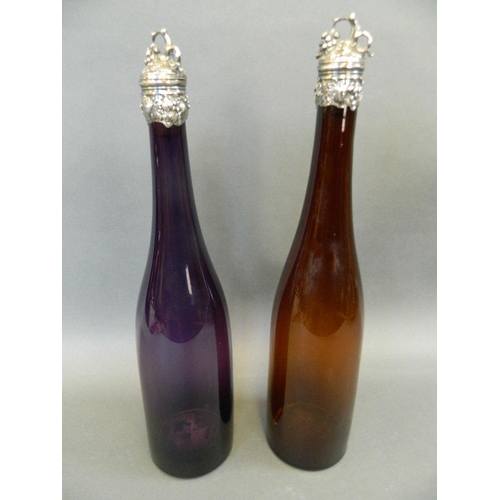 516 - An amethyst glass wine decanter with white metal collar and stopper decorated with grape vines, toge... 