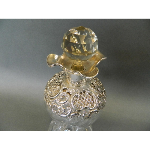 518 - A dimple glass decanter with ornate chased and pierced Hallmarked silver collar, 9½