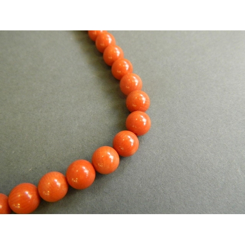 548 - A string of coral style beads, 17