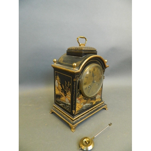 560 - A 1920s black lacquered wood mantle clock with chinoiserie decoration, 7½