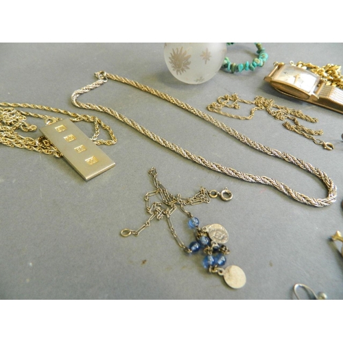 562 - A quantity of assorted costume jewellery comprising 18ct gold plated wristwatch, chains, pendants et... 