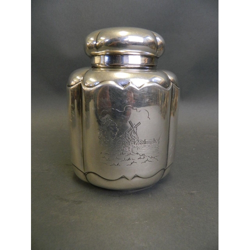 571 - A Dutch white metal tea caddy with engraved canal scene and heraldic decoration, impressed 'K-90' to... 