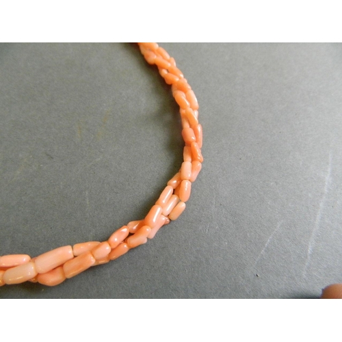 573 - A three strand coral necklace, together with a graduated emerald shard necklace, longest 22