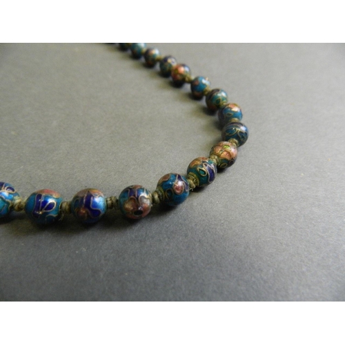 575 - A lapis lazuli bead necklace with silver clasp, together with a Chinese cloisonné bead necklace, lon... 