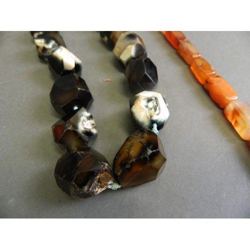 576 - A cornelian graduated bead necklace, together with a natural agate bead necklace, longest 42