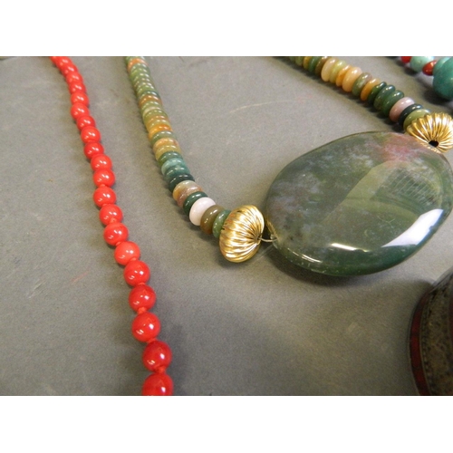 579 - A collection of semi-precious stone necklaces to include malachite, coral, turquoise, and jade, toge... 