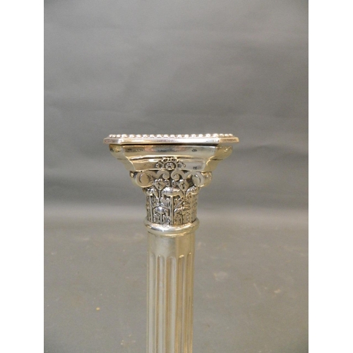 587 - A pair of Corinthian column Hallmarked silver candlesticks, 12