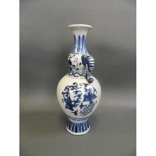 59 - A Chinese blue and white porcelain double gourd vase with twin elephant mask handles and painted pho... 