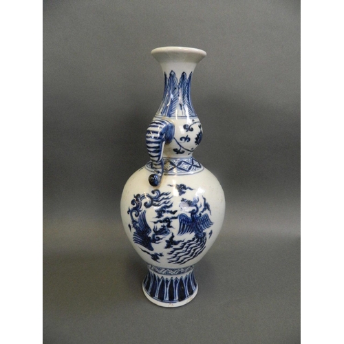 59 - A Chinese blue and white porcelain double gourd vase with twin elephant mask handles and painted pho... 