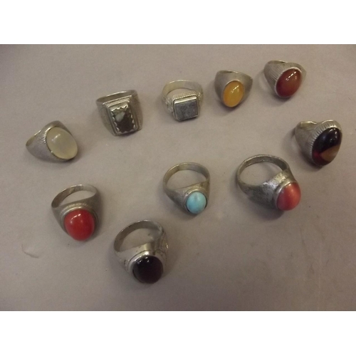 590 - A collection of Middle Eastern white metal/low grade silver rings set with semi-precious stones