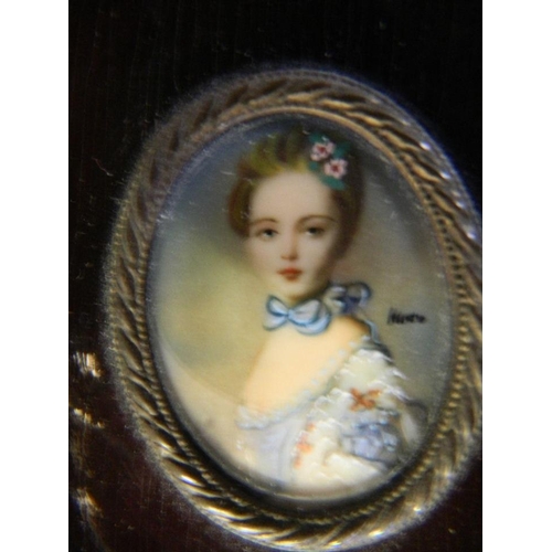 611 - A miniature oval portrait of a young girl, signed indistinctly, in a good hardwood frame, 3½