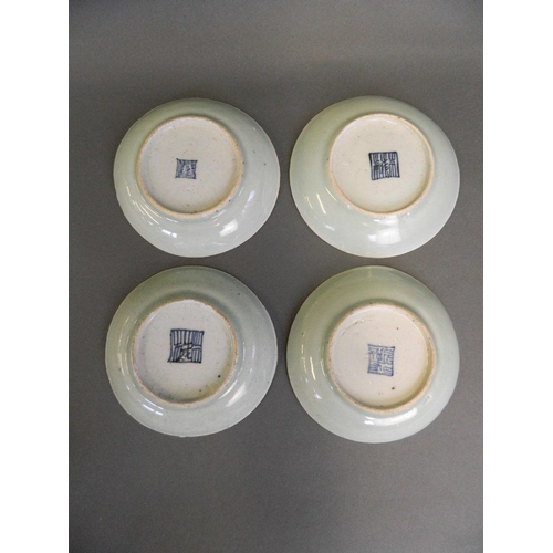 62 - A collection of four Chinese porcelain saucer dishes with celadon glaze and polychrome enamel decora... 