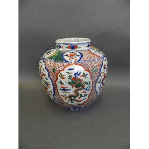 63 - A Chinese Wucai enamel porcelain jar of ribbed form with decorative panels depicting dragons chasing... 