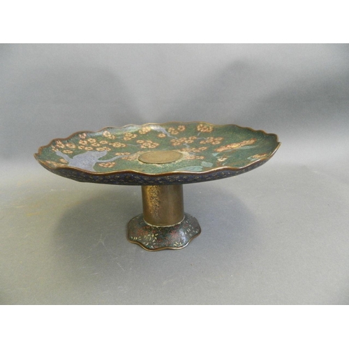 68 - A Chinese cloisonné cake stand with prunus tree and floral decoration, on a brass stand with 6 chara... 