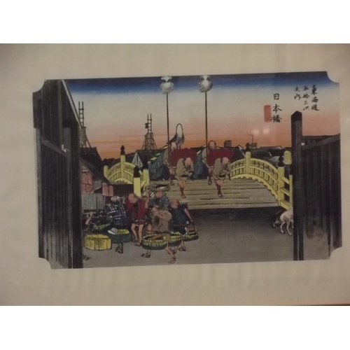 684 - A pair of colour prints of Japanese woodcuts, travellers on a bridge and figures with horses