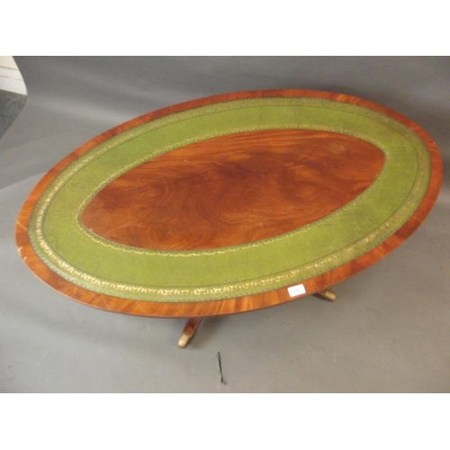 708 - A mahogany oval shaped occasional table with inset leather top, raised on a turned column and splay ... 