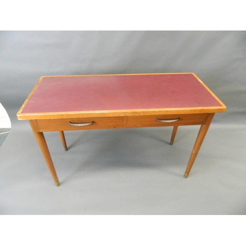 709 - A mid C20th two drawer writing table with inset top, raised on turned tapering supports, 21