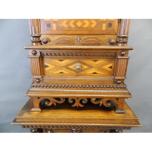 713 - A C19th Italian oak two section cabinet with parquetry inlaid panels and moulded and beaded decorati... 