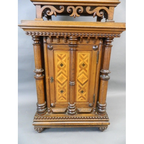 713 - A C19th Italian oak two section cabinet with parquetry inlaid panels and moulded and beaded decorati... 