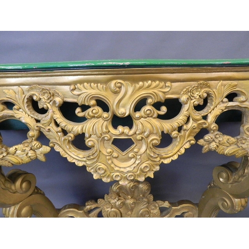 714 - A pair of giltwood console tables with serpentine shaped and carved painted tops, 55