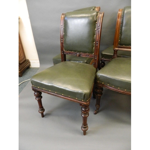 715 - A matched set of six Victorian oak dining chairs with brass studded leatherette covers and carved de... 