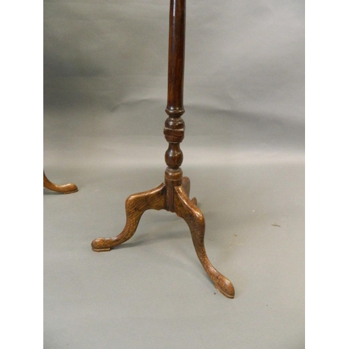 722 - A pair of antique elm occasional tables, raised on turned columns and tripod supports with pad feet,... 