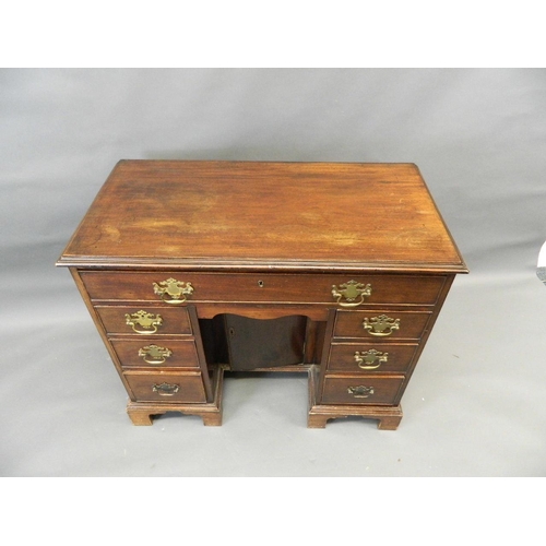 732 - A Georgian mahogany seven drawer kneehole desk with central pigeonhole cupboard and cock beaded draw... 