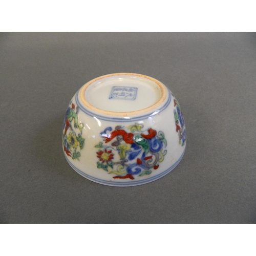 75 - A Chinese Doucai enamelled porcelain tea bowl decorated with kylin and flowers, 6 character mark to ... 