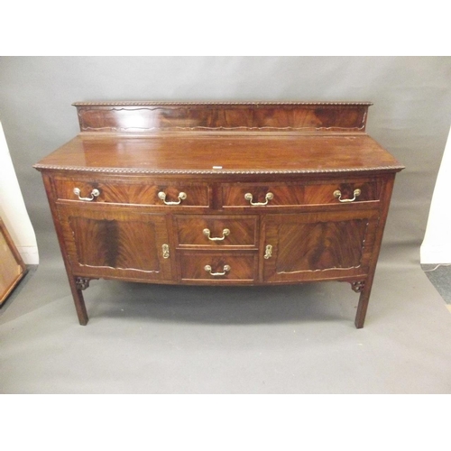 757 - A Georgian style mahogany bow fronted sideboard with two drawers over two cupboards flanking two mor... 