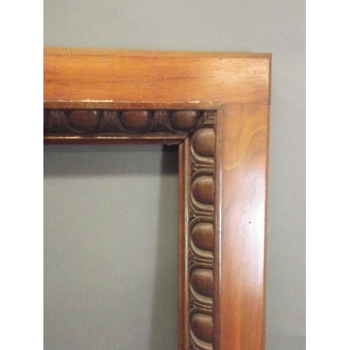 765 - A Victorian walnut mirror frame with egg and dart carved decoration, 27