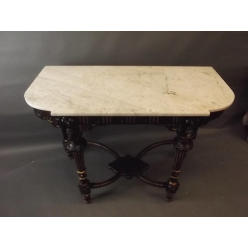 778 - A C19th ebonised and parcel gilt console table with crossed stretchers and undertier, and marble top... 