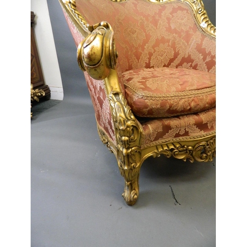 781 - A pair of giltwood easy chairs with carved and pierced frames and scrolled arms, with shaped fronts,... 