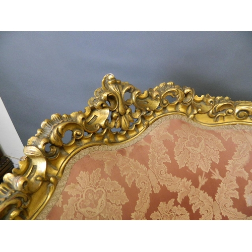 781 - A pair of giltwood easy chairs with carved and pierced frames and scrolled arms, with shaped fronts,... 