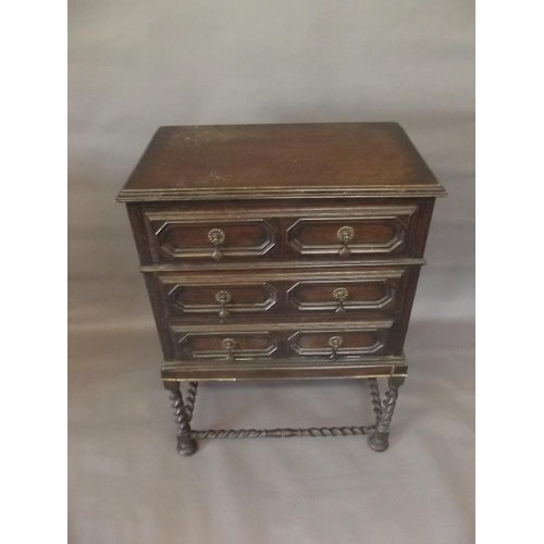 786 - A Jacobean style oak chest of three drawers with moulded fronts, raised on a barleytwist stand, 18