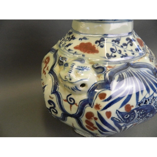 79 - A Chinese Ming style blue and white vase of octagonal form with twin mask handles, decorated with dr... 