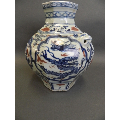 79 - A Chinese Ming style blue and white vase of octagonal form with twin mask handles, decorated with dr... 