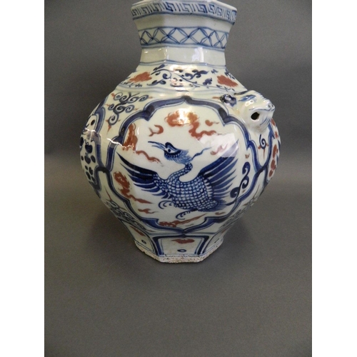 79 - A Chinese Ming style blue and white vase of octagonal form with twin mask handles, decorated with dr... 