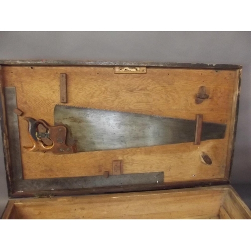 808 - A C19th pine tool chest with filled compartments containing old saws, planes, tools etc, 37