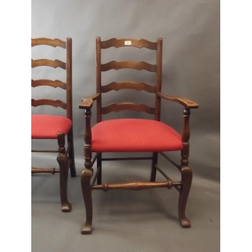 812 - A set of six oak ladderback chairs raised on shaped supports