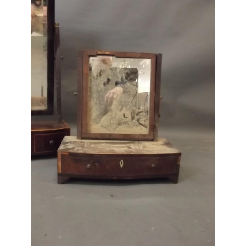 821 - A George III inlaid mahogany three drawer swing toilet mirror, and another smaller, 21