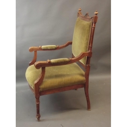 833 - A French walnut framed open armchair with carved crest rail, on reeded turned columns and legs, 20