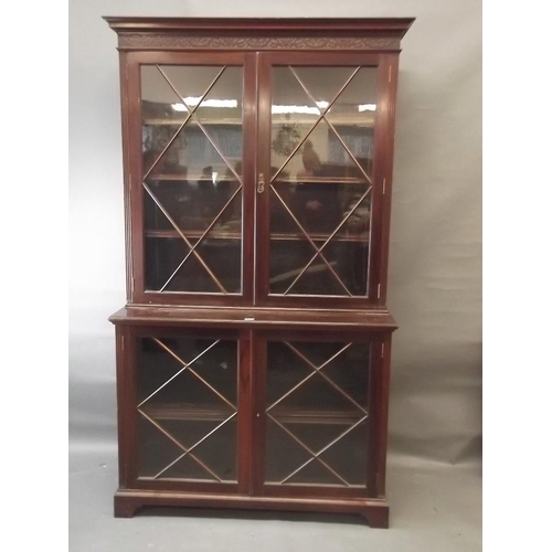 842 - A late C19th/early C20th mahogany two section display cabinet with glazed upper and lower sections w... 