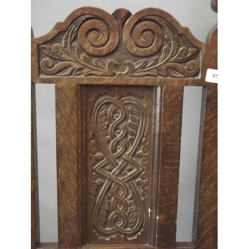 856 - A C19th carved oak side chair with panelled seat