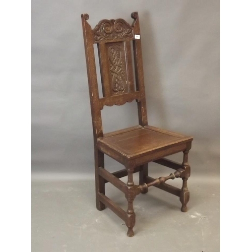 856 - A C19th carved oak side chair with panelled seat