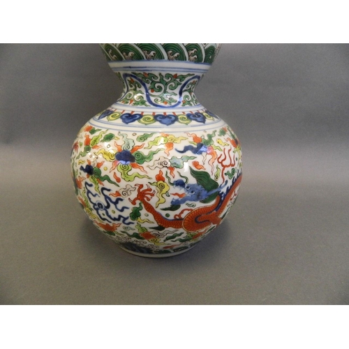 86 - A Chinese Doucai enamelled porcelain double gourd vase decorated with dragons chasing the flaming pe... 