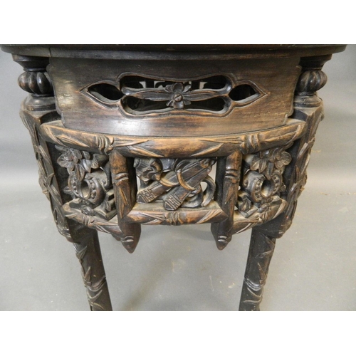 861 - A Chinese hardwood jardinière stand with carved and pierced frieze and inset marble top, late C19th/... 