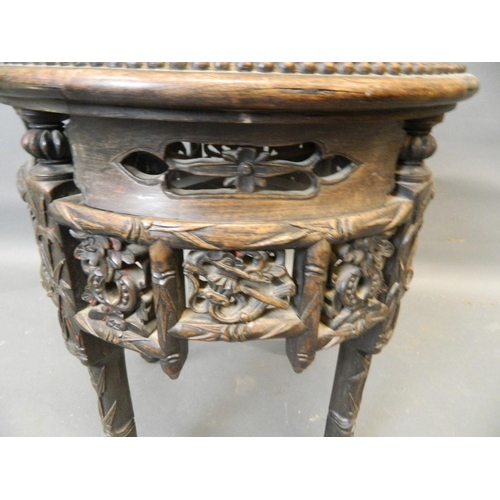 861 - A Chinese hardwood jardinière stand with carved and pierced frieze and inset marble top, late C19th/... 