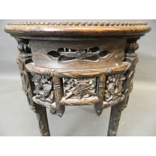 861 - A Chinese hardwood jardinière stand with carved and pierced frieze and inset marble top, late C19th/... 