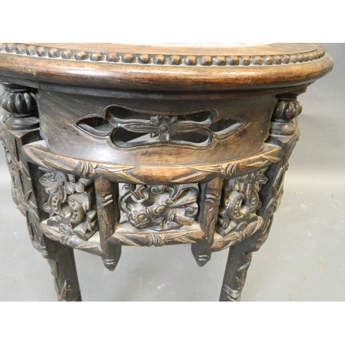 861 - A Chinese hardwood jardinière stand with carved and pierced frieze and inset marble top, late C19th/... 